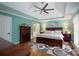 Bright main bedroom with a ceiling fan, an ensuite bathroom, modern decor, and hardwood floors at 785 Sanside Dr, York, SC 29745