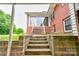 View of stairs leading up to an enclosed back patio from the covered parking area at 800 Charles Rd, Shelby, NC 28150