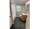 Updated bathroom featuring black hexagon tile floors, modern vanity and a tub with shower at 800 Charles Rd, Shelby, NC 28150