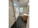 Updated bathroom featuring black hexagon tile floors, modern vanity and a tub with shower at 800 Charles Rd, Shelby, NC 28150