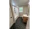 Updated bathroom featuring black hexagon tile floors, modern vanity and a tub with shower at 800 Charles Rd, Shelby, NC 28150