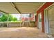 Covered parking area attached to the brick home's backyard with stairs leading to enclosed patio at 800 Charles Rd, Shelby, NC 28150