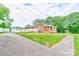 Charming single-story brick home with a ramp and a well-manicured lawn and mature trees at 800 Charles Rd, Shelby, NC 28150