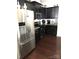 Modern kitchen featuring stainless steel appliances and dark wood cabinets at 8039 Scarlet Oak Ter, Fort Mill, SC 29707
