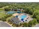 Community amenities featuring tennis courts, swimming pool, clubhouse, and manicured landscaping at 8441 Sandowne Ln, Huntersville, NC 28078