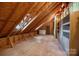 Unfinished attic space with exposed beams and plywood flooring at 8441 Sandowne Ln, Huntersville, NC 28078