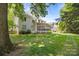Expansive backyard with well-maintained lawn, screened porch, and charming picket fence, perfect for outdoor relaxation at 8441 Sandowne Ln, Huntersville, NC 28078