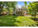 Spacious backyard featuring a screened porch, patio, and lush green grass surrounded by mature trees at 8441 Sandowne Ln, Huntersville, NC 28078