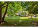 View of the backyard featuring a screened porch, patio area, and lush green lawn at 8441 Sandowne Ln, Huntersville, NC 28078