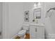 Clean powder room with modern fixtures, vanity, and framed artwork at 8441 Sandowne Ln, Huntersville, NC 28078