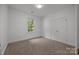 Bedroom features natural light from a large window and a double door closet at 8441 Sandowne Ln, Huntersville, NC 28078