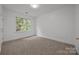 Bedroom features natural light from a large window at 8441 Sandowne Ln, Huntersville, NC 28078