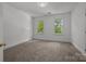 Bedroom featuring natural light from two large windows at 8441 Sandowne Ln, Huntersville, NC 28078