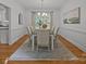 Formal dining room featuring a modern chandelier, hardwood floors, and wainscoting at 8441 Sandowne Ln, Huntersville, NC 28078