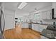 Bright kitchen with white cabinets, granite countertops, and hardwood floors at 8441 Sandowne Ln, Huntersville, NC 28078