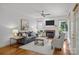 Bright living room featuring a fireplace, neutral decor, and hardwood floors at 8441 Sandowne Ln, Huntersville, NC 28078