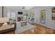 Comfortable living room with a cozy fireplace and large windows providing natural light at 8441 Sandowne Ln, Huntersville, NC 28078