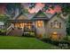 The rear exterior of this home boasts a covered deck, brick facade, and landscaped yard at 9002 Fair Oak Dr, Sherrills Ford, NC 28673