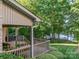 Inviting back porch with wood flooring overlooking the lush backyard and beautiful lake view at 9002 Fair Oak Dr, Sherrills Ford, NC 28673
