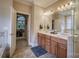 Bathroom featuring a double sink vanity, tiled floors and a door leading to the main bedroom at 9002 Fair Oak Dr, Sherrills Ford, NC 28673