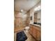 Tiled bathroom featuring a frameless shower, modern fixtures, and a vanity with dark granite counters at 9002 Fair Oak Dr, Sherrills Ford, NC 28673