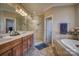 Bathroom featuring a double sink vanity, a bathtub, and a glass-enclosed shower at 9002 Fair Oak Dr, Sherrills Ford, NC 28673