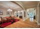 Open-concept dining room with hardwood floors, arched doorways, and elegant lighting fixtures at 9002 Fair Oak Dr, Sherrills Ford, NC 28673