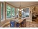 Bright dining area filled with natural light featuring beautiful tile floors and views of the lush landscaping at 9002 Fair Oak Dr, Sherrills Ford, NC 28673