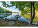 Scenic lake view showcasing a private boat dock with boats moored in the calm water on a clear day at 9002 Fair Oak Dr, Sherrills Ford, NC 28673