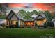 Charming brick home with lush landscaping, mature trees and a welcoming front entrance at 9002 Fair Oak Dr, Sherrills Ford, NC 28673