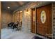 Covered front porch with brick walls, an arched window, and a wooden front door with stained glass at 9002 Fair Oak Dr, Sherrills Ford, NC 28673
