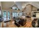 Bright and airy living room with vaulted ceilings, a stone fireplace, and built-in shelving at 9002 Fair Oak Dr, Sherrills Ford, NC 28673
