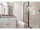 Updated bathroom with a granite-topped vanity, glass-enclosed shower, and neutral tile provides a spa-like experience at 9104 Kingsmead Ln, Waxhaw, NC 28173