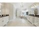 Bright bathroom featuring a large tub, tiled floors, and and sinks with granite countertops at 9104 Kingsmead Ln, Waxhaw, NC 28173
