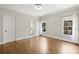 Spacious bedroom with hardwood floors, ample natural light, and a view into the en-suite bathroom offers a comfortable retreat at 9104 Kingsmead Ln, Waxhaw, NC 28173