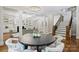 Open dining area with hardwood floors and a staircase with iron railings at 9104 Kingsmead Ln, Waxhaw, NC 28173