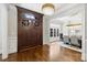 Elegant foyer featuring hardwood floors, front door, and dining view at 9104 Kingsmead Ln, Waxhaw, NC 28173