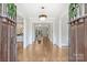 Elegant foyer features hardwood floors, chandelier, and decorative molding at 9104 Kingsmead Ln, Waxhaw, NC 28173
