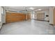 Spacious garage with epoxy flooring, wood doors and shelving at 9104 Kingsmead Ln, Waxhaw, NC 28173