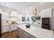 Bright kitchen features white cabinets, stainless appliances, and large island with quartz countertops at 9104 Kingsmead Ln, Waxhaw, NC 28173