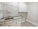 Functional laundry room with granite countertops, ample cabinet storage, and modern appliances enhances efficiency at 9104 Kingsmead Ln, Waxhaw, NC 28173