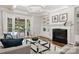 Comfortable living room featuring a fireplace, built-in shelving, and access to an outdoor patio at 9104 Kingsmead Ln, Waxhaw, NC 28173