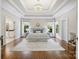 Spacious main bedroom featuring trey ceiling, decorative chandelier, large windows, and hardwood floors at 9104 Kingsmead Ln, Waxhaw, NC 28173