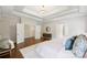 Relaxing main bedroom with tray ceiling, dresser, and view to ensuite bathroom and closet at 9104 Kingsmead Ln, Waxhaw, NC 28173