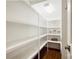 Walk-in pantry features ample shelving for organized storage and easy access at 9104 Kingsmead Ln, Waxhaw, NC 28173