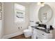 Elegant powder room featuring a black marble countertop, ornate vanity, and decorative mirror creates a sophisticated touch at 9104 Kingsmead Ln, Waxhaw, NC 28173