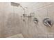 Luxurious shower features tile surround and rainfall shower head at 9104 Kingsmead Ln, Waxhaw, NC 28173