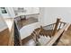 Wooden staircase featuring a dark metal railing and providing access to the upper floors at 9104 Kingsmead Ln, Waxhaw, NC 28173