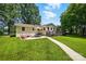 Charming backyard with patio, deck, green lawn, and mature trees, perfect for outdoor living and entertaining at 103 W Sunset Dr, Locust, NC 28097