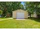 Detached one car garage in a spacious backyard setting with a play set in the background at 103 W Sunset Dr, Locust, NC 28097